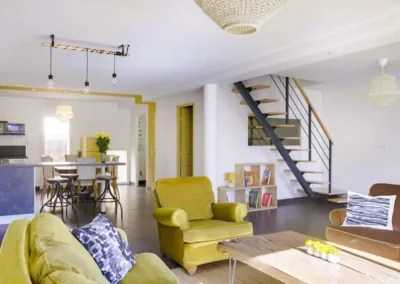 Loft Nature Bien Etre, large living room with kitchen in background reservation airbnb online vacations