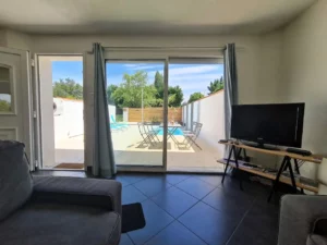 Gite with large living room overlooking terrace, swimming pool and garden furniture