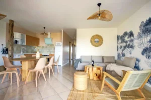 Open-plan living room with sofa bed overlooking dining room for 6 and fully equipped open kitchen