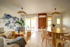 Open-plan living room with sofa bed and view of dining room for 6